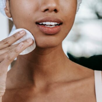 Woman removing her makeup with cotton pads