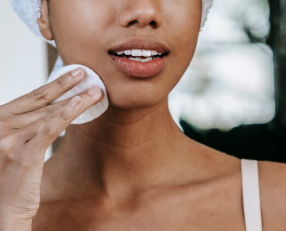 Woman removing her makeup with cotton pads