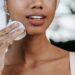 Woman removing her makeup with cotton pads