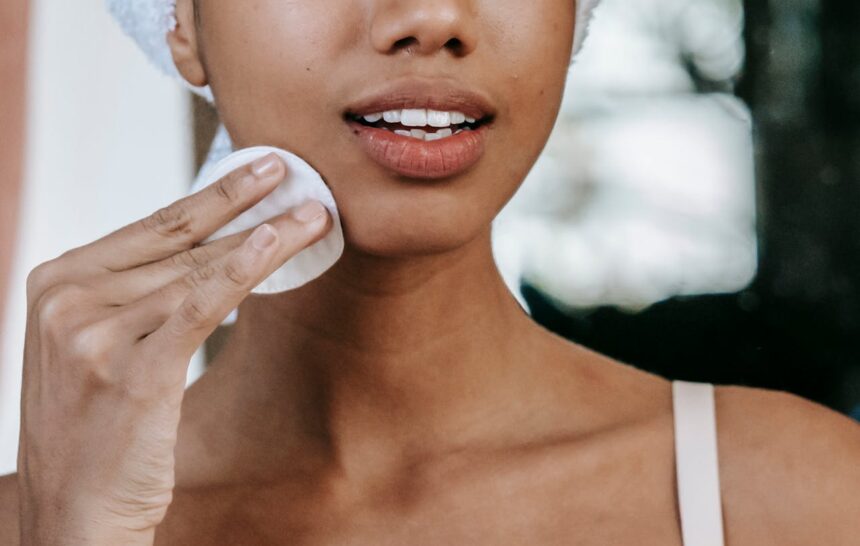 Woman removing her makeup with cotton pads