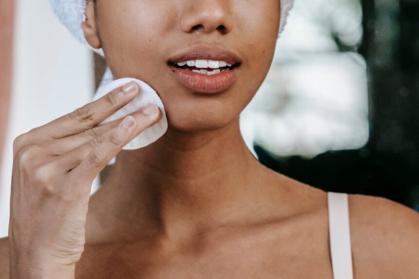 Woman removing her makeup with cotton pads