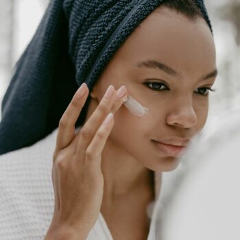 RETINOL Black woman applying a Retinol cream