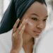 Black woman applying a Retinol cream