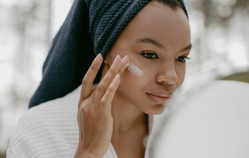 Black woman applying a Retinol cream