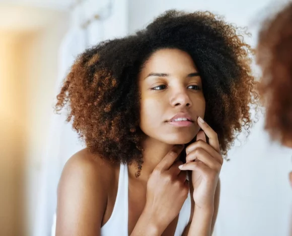 hyaluronic-acid-free-korean-skincare-sensitive-skin-barrier-repair Woman examining sensitive facial skin before using Hyaluronic acid-free Korean skincare