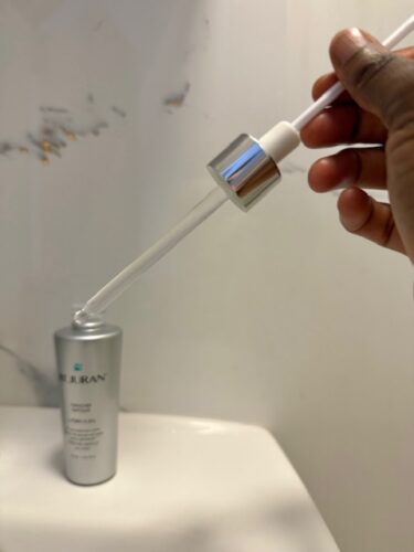 Close-up of the Rejuran Turnover Ampoule dropper showing the PDRN serum texture before application.