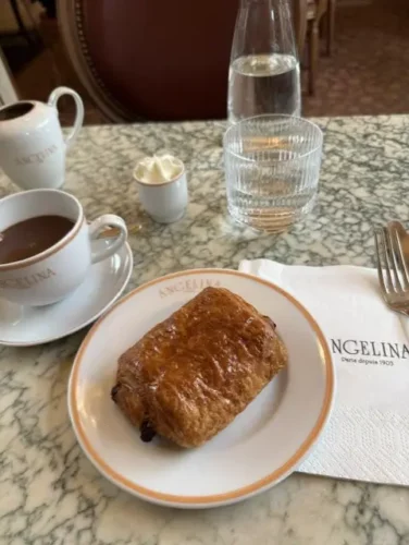 Breakfast at Angelina Paris featuring the famous hot chocolate and a buttery pain au chocolat in the iconic Parisian tearoom.