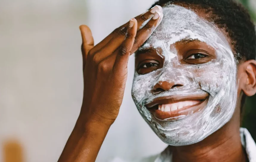 healing-skin-after-hydroquinone-bleaching Black woman with facial skin bleaching damage using a clay mask to soothe and heal her skin