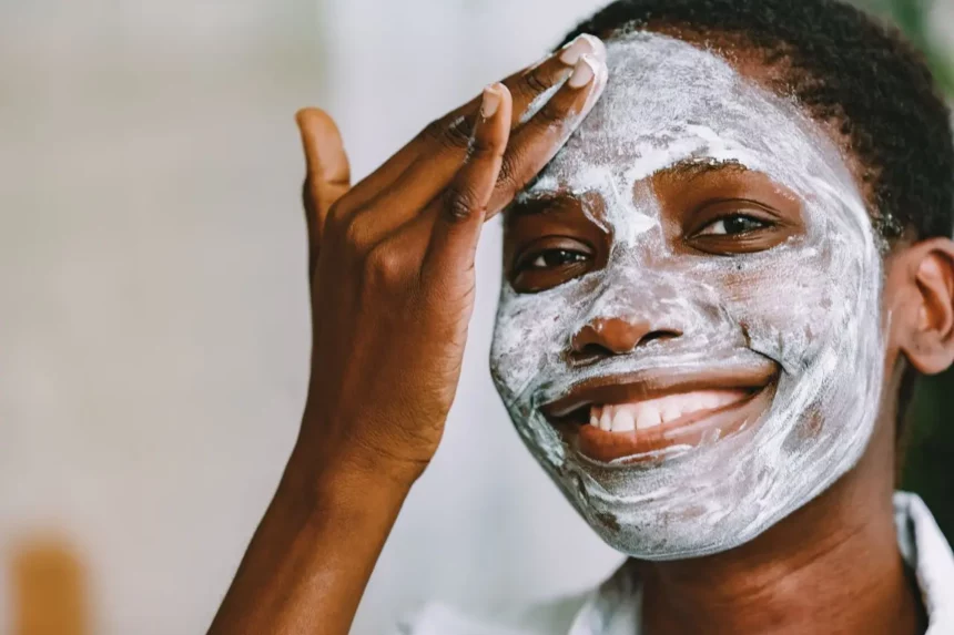 healing-skin-after-hydroquinone-bleaching Black woman with facial skin bleaching damage using a clay mask to soothe and heal her skin